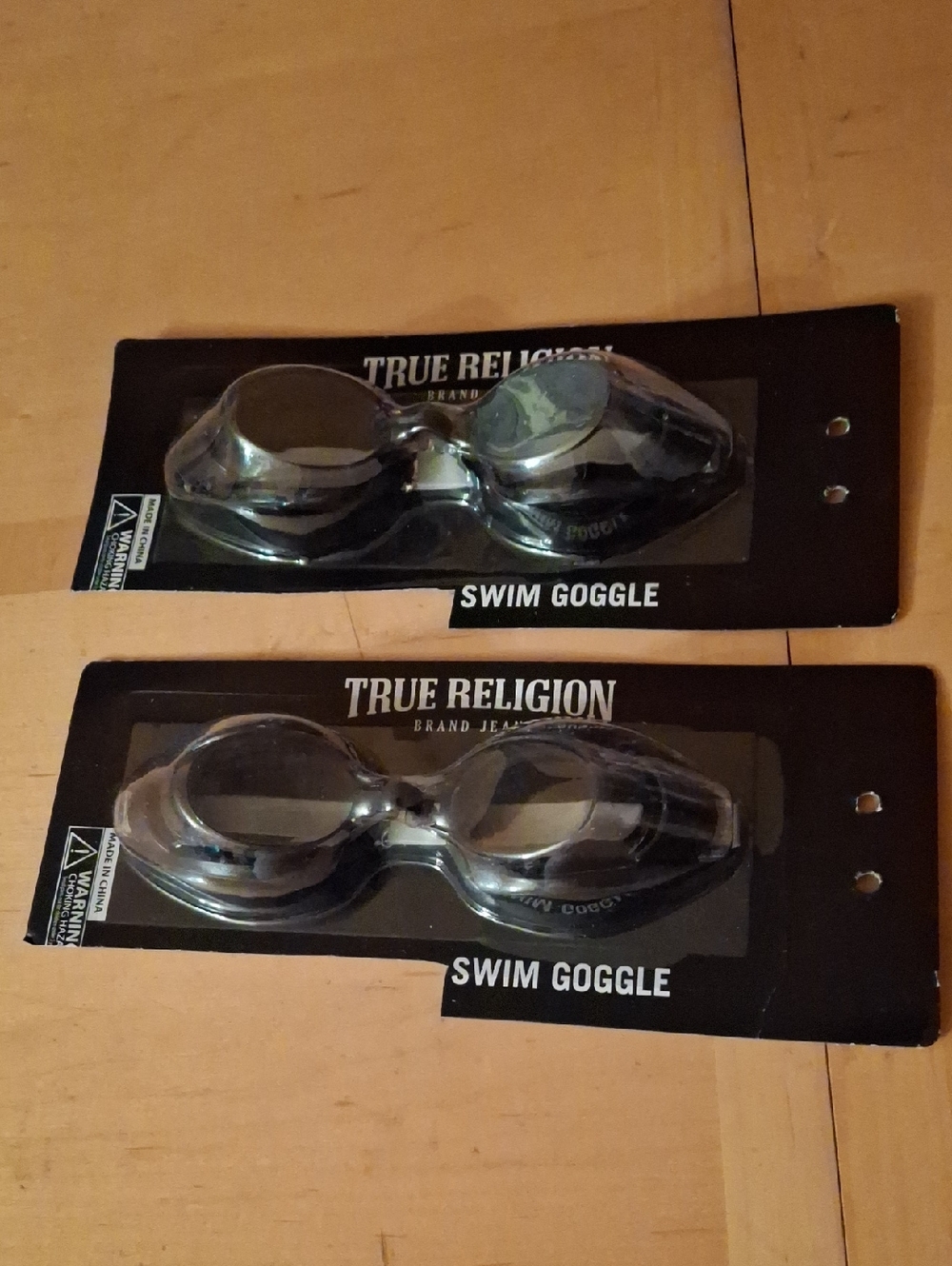 True Religion Men's Clear Swim Goggles with Black Cardback